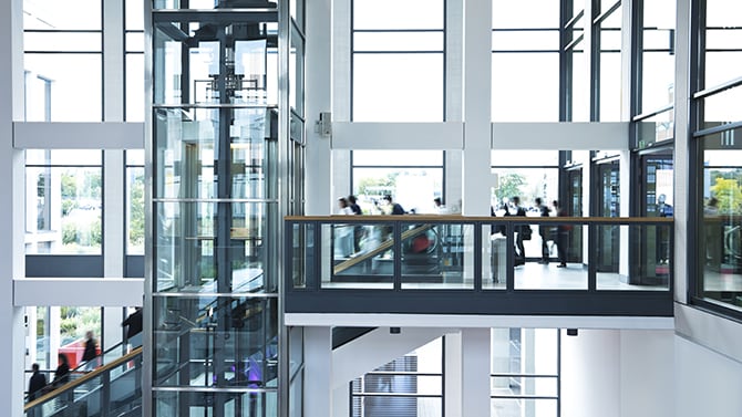 glass office building and employess moving around